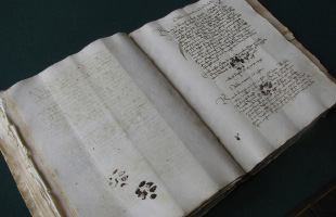 Medieval manuscript with cat prints on it