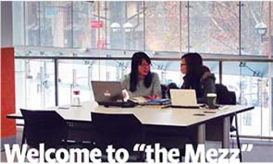 Photo of two students studying in the mezzanine study space.